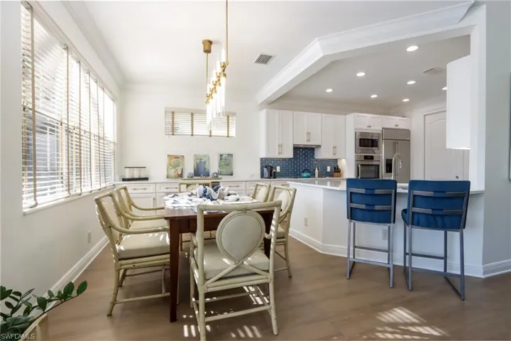 Dining room featuring crown molding, wood finished floors, and recessed lighting