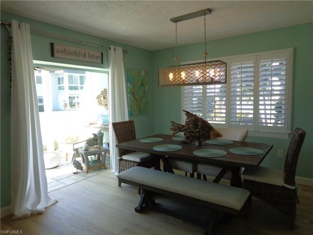 STEPS OUT ONTO THE FLORIDA ROOM WHERE YOU CAN RELAX, ENJOY THE SUNSHINE AND GAZE AT THE SUNLIGHT ON THE RIVER.