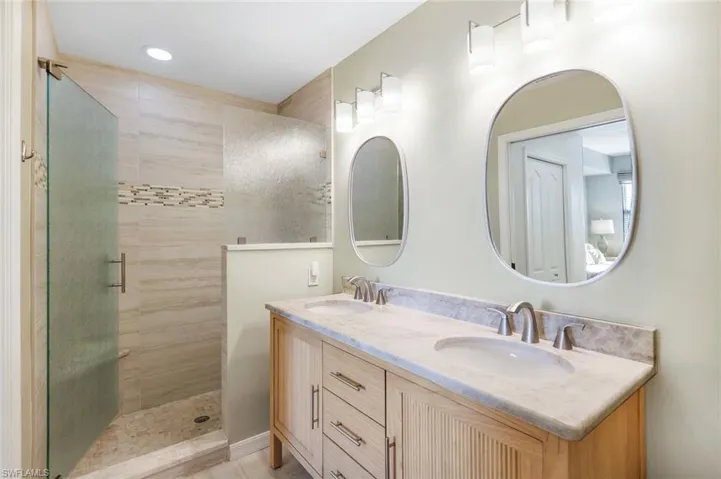 Bathroom with vanity and a tile shower