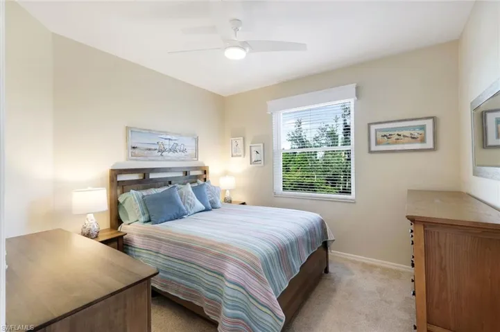Carpeted bedroom with ceiling fan