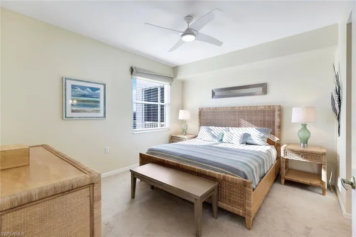 Carpeted bedroom featuring ceiling fan