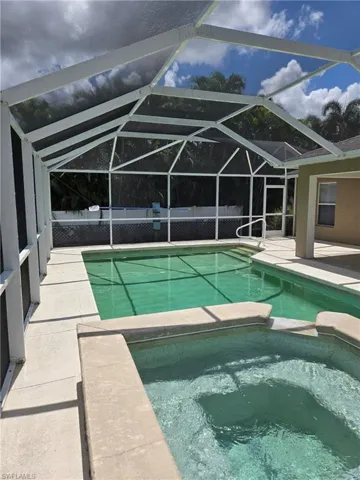 View of swimming pool with a pool with connected hot tub and a patio