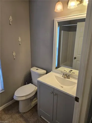 Full bath with vanity and tile patterned floors