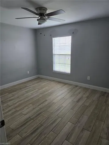 Unfurnished room featuring ceiling fan and wood finished floors