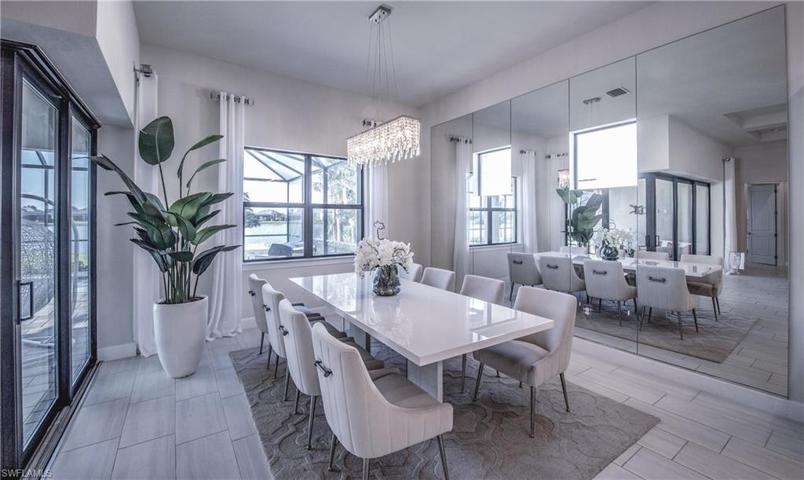 DINING ROOM WITH MIRROR TO THE RIGHT OF PIC