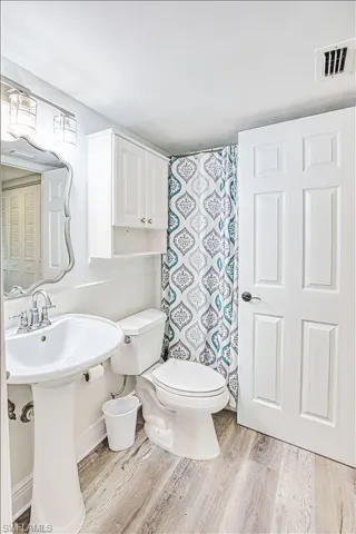 Bathroom featuring light wood-style floors and a shower with shower curtain