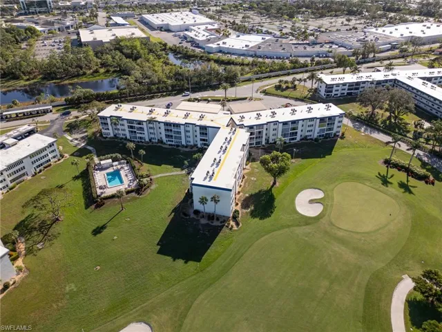 Drone / aerial view of a nearby body of water and a local golf course