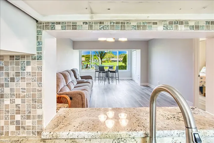 Living area with light wood finished floors and baseboards