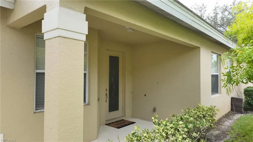 View of exterior entry with stucco siding