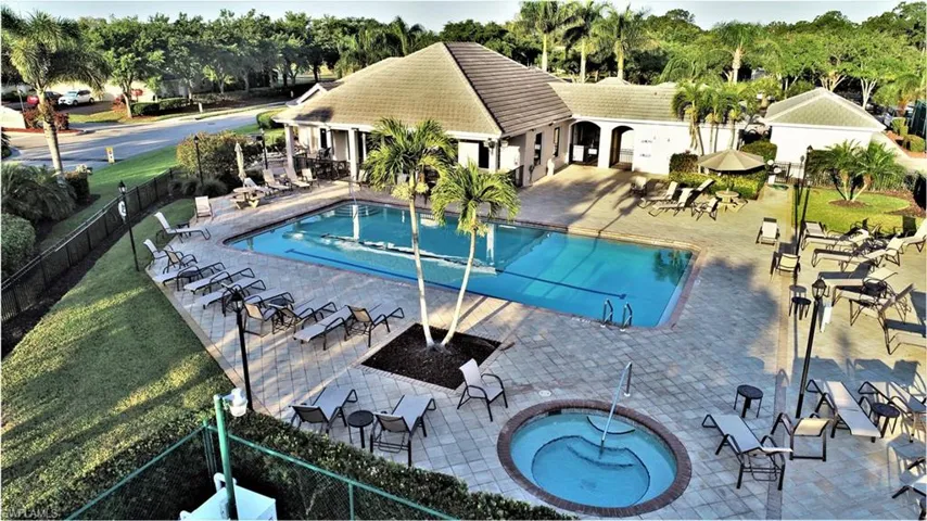 Community pool with a patio area and a community hot tub
