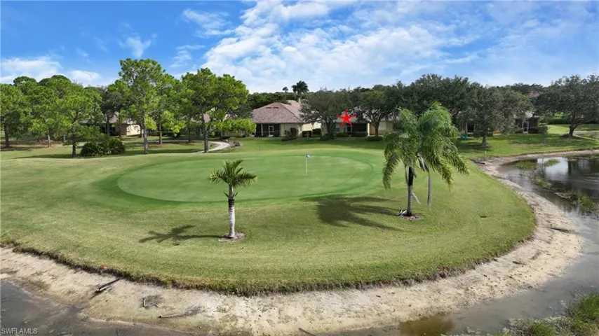 View of home's community with a water view, view of golf course, and view of scattered trees