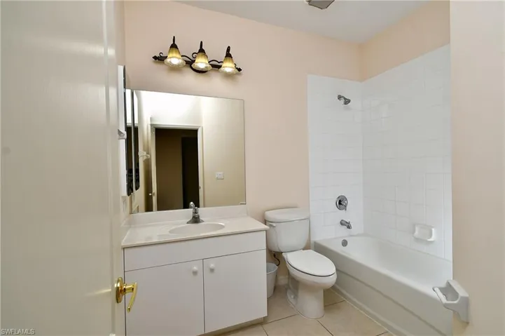 Full bathroom with  shower combination, vanity, and light tile patterned floors