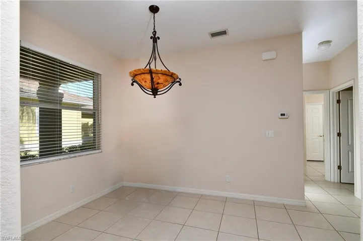 Empty room with light tile patterned floors
