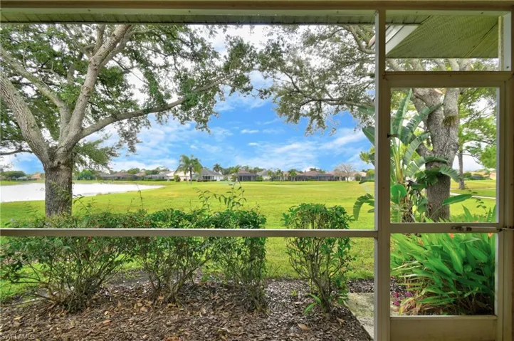 View of green lawn with a residential view