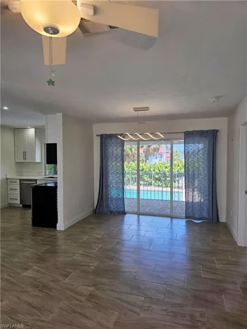 Empty room featuring ceiling fan and wood finish floors