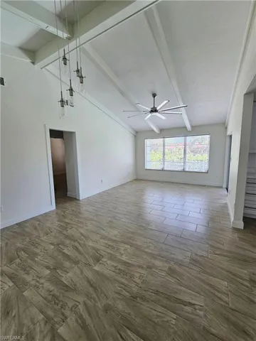 Spare room with baseboards and ceiling fan