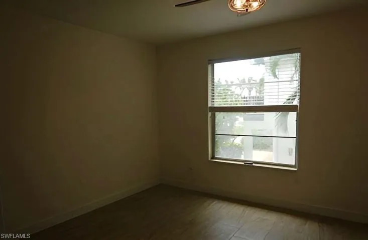 Unfurnished room featuring wood finished floors and a ceiling fan