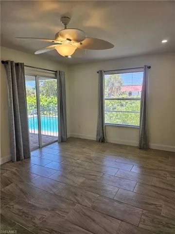 Unfurnished room with healthy amount of natural light and a ceiling fan