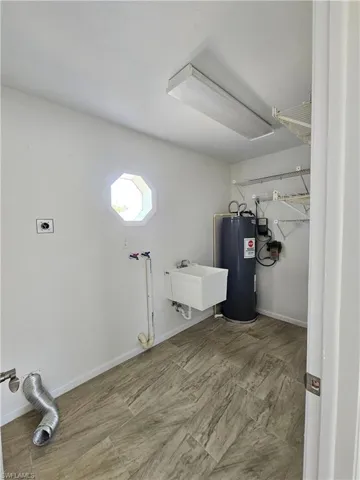 Laundry room featuring water heater, electric dryer hookup, and hookup for a washing machine
