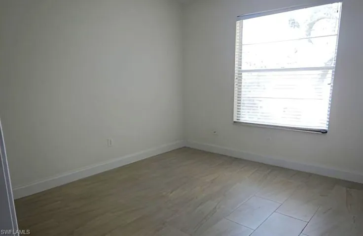 Unfurnished room featuring baseboards