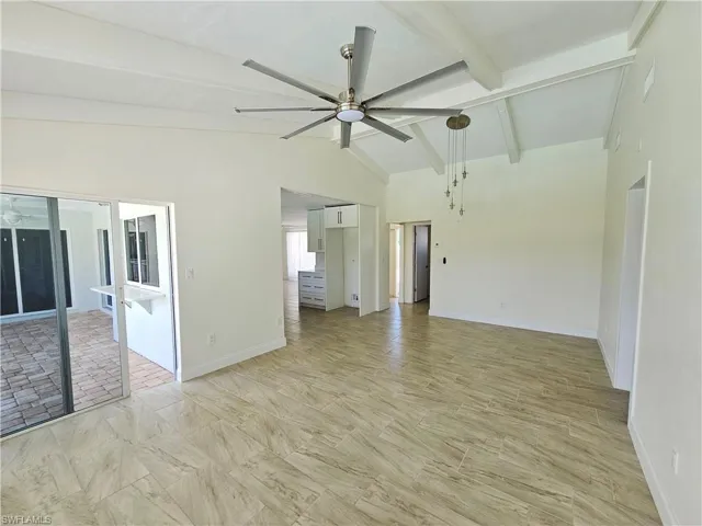 Unfurnished room with ceiling fan and baseboards
