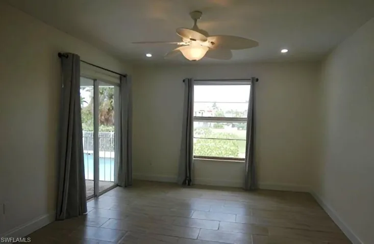 Unfurnished room with wood finished floors, a ceiling fan, and recessed lighting
