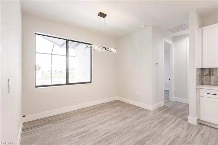 Unfurnished room featuring light wood-type flooring
