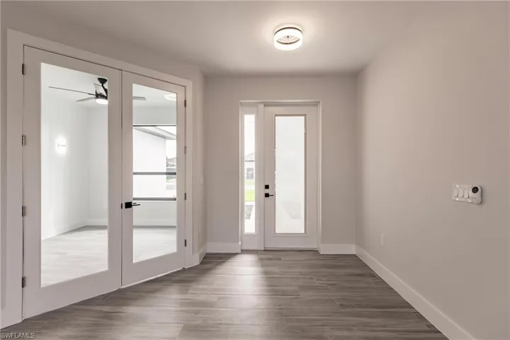 Doorway featuring ceiling fan, french doors, and dark hardwood / wood-style flooring