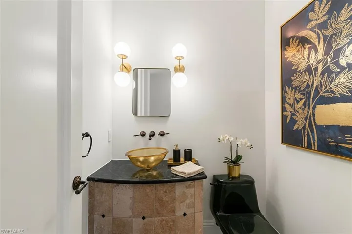 Half bath with vanity, located just off of the living room