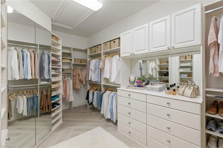 Spacious custom closet system features Ashford porcelain Honey Blonde Oak tile