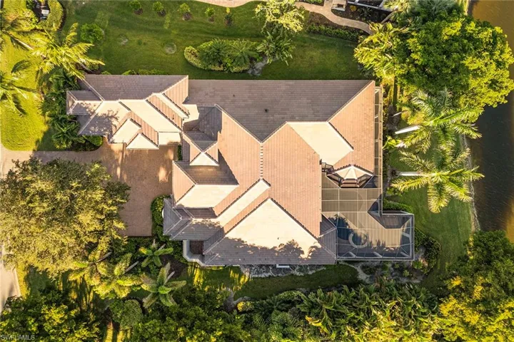 Aerial View showing the new 2025 roof and amazing location surrounded by mature lime, banana, and avocado plantings for your own backyard harvest