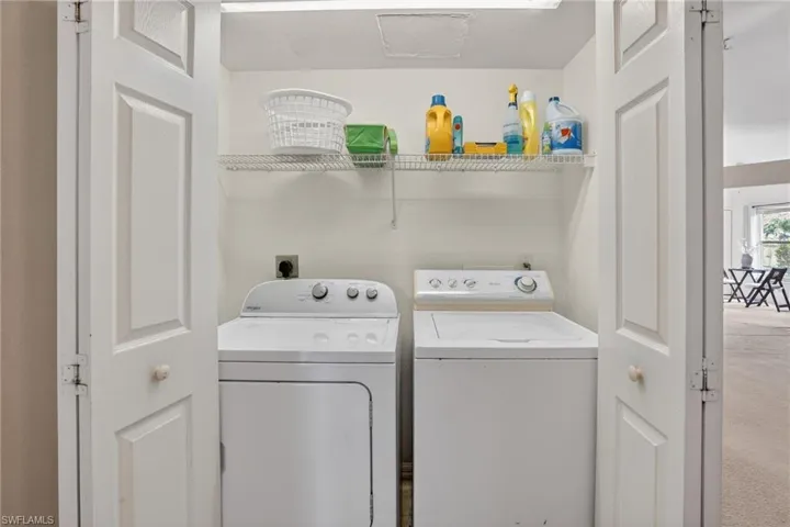 Washroom featuring washing machine and dryer