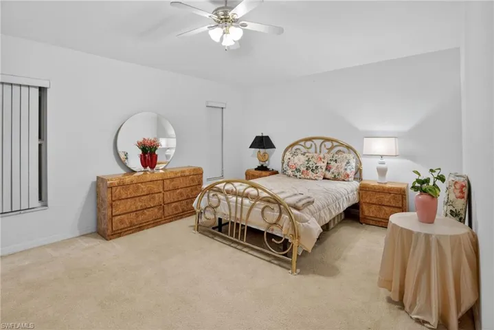 Bedroom with carpet, ceiling fan, and a closet