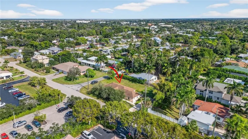 Aerial view of property and surrounding area with nearby suburban area