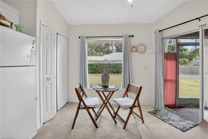 Dining room featuring healthy amount of natural light and light colored carpet