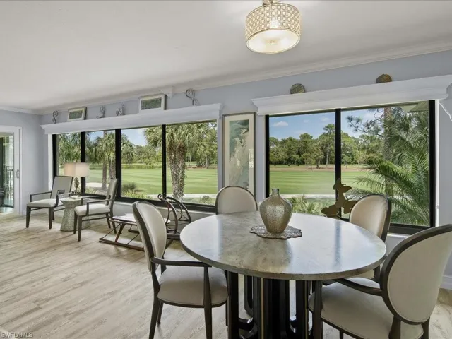 Large dining space and updated lighting . Note the crown moldings , window treatments are hidding behind the molding
