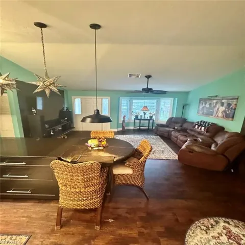Dining room with ceiling fan, and vaulted ceiling