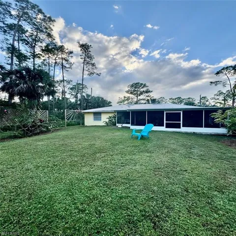 View of yard + back of home
