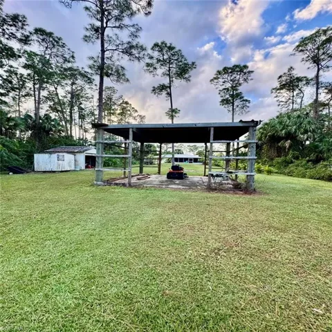 View of yard with over sized shed and pole barn