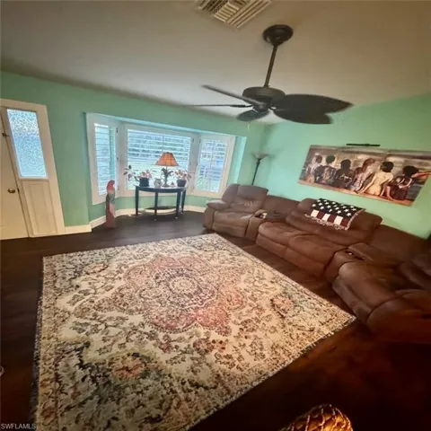 Living room featuring luxury vinyl flooring and ceiling fan