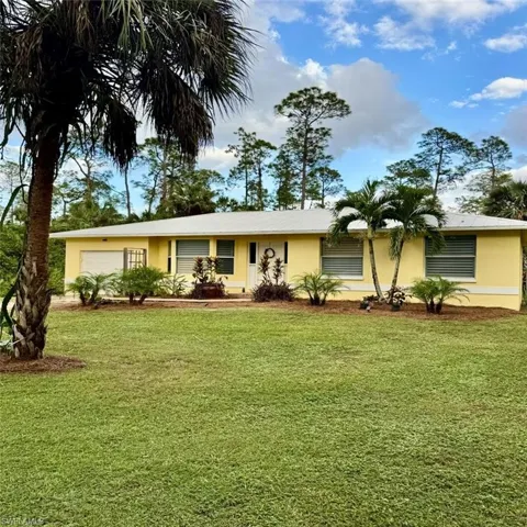 Single story home featuring a front lawn and a single car garage