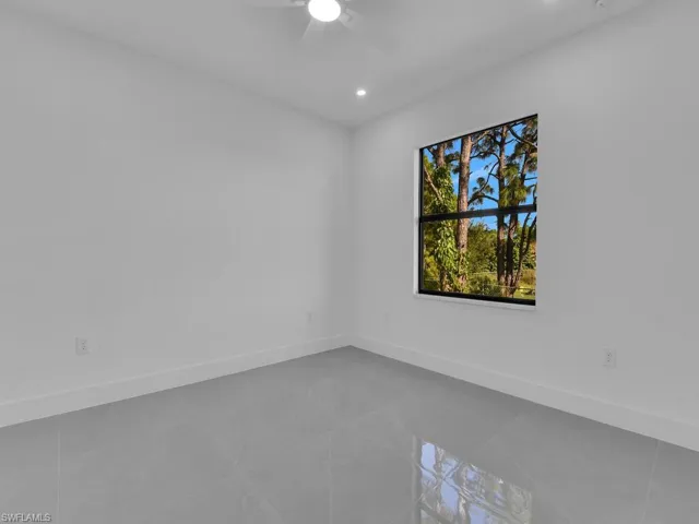 Tiled spare room featuring recessed lighting and ceiling fan