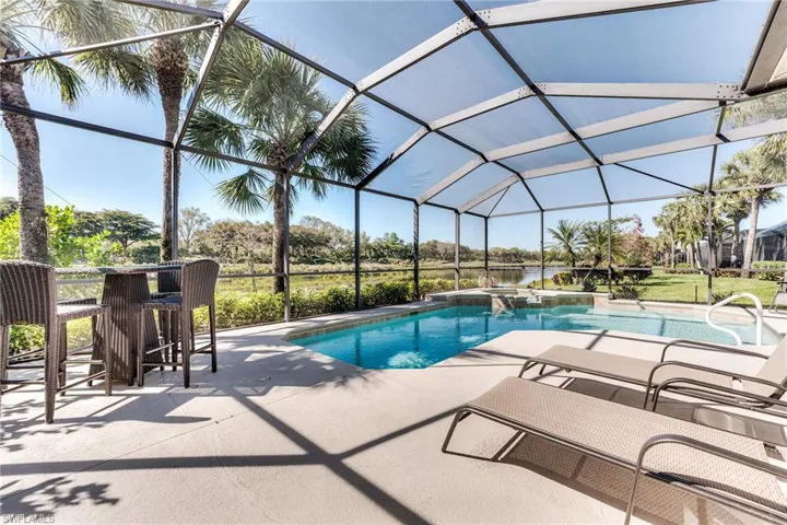Outdoor pool with glass enclosure and a patio