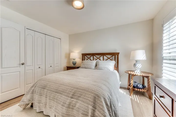 Bedroom with light wood finished floors and a closet