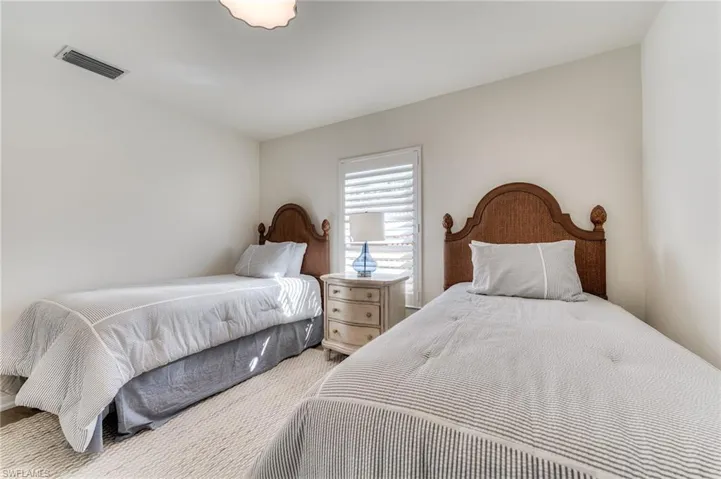 Carpeted bedroom with visible vents