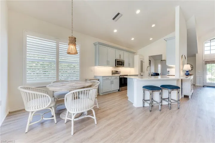 Kitchen with visible vents, decorative backsplash, appliances with stainless steel finishes, gray cabinets, and light wood-type flooring