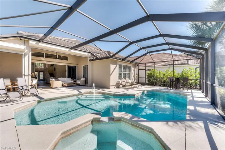 View of swimming pool featuring a patio, a pool with connected hot tub, an outdoor hangout area, a ceiling fan, and a lanai