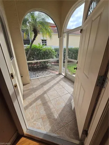 Tiled & Screened Entry. Small window in kitchen with entry view.