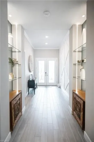 Corridor with french doors and crown molding