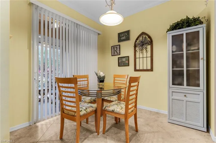 Dining area featuring crown molding and light tile patterned flooring